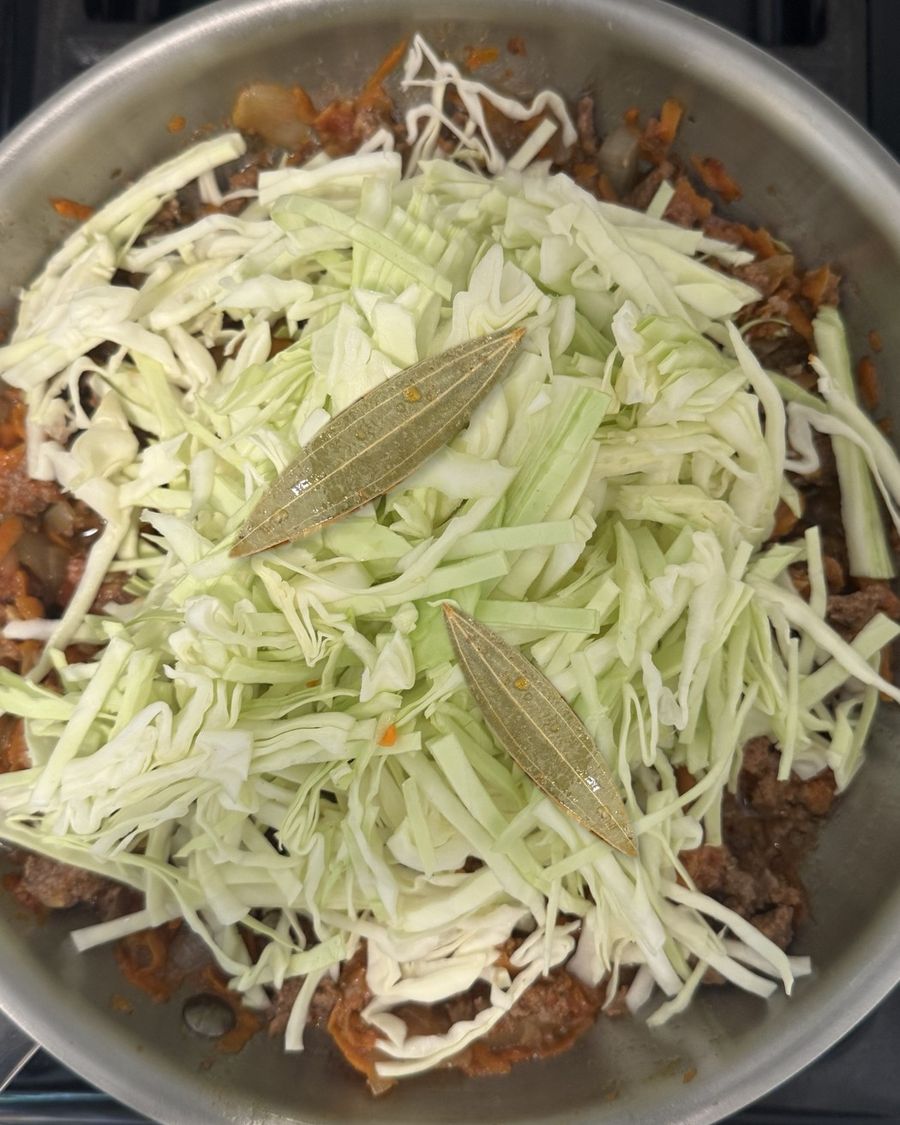 Shredded cabbage and bay leaves added