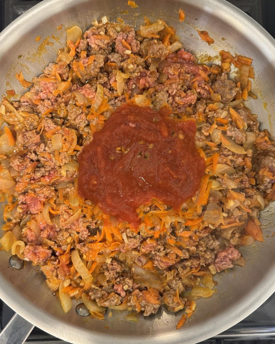 Tomato sauce stirred in